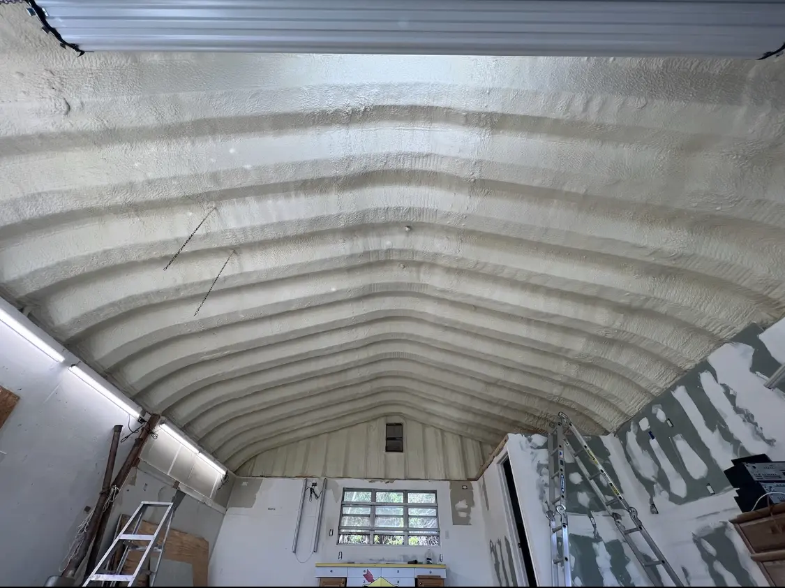 Spray polyurethane foam applied to the underside of a metal roof deck in Kings Point